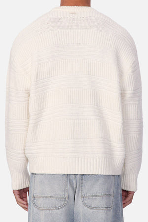 Person wearing an Industrie The Huntington Knit crew neck sweater with a textured pattern and light blue denim jeans, shown from the back against a plain background.