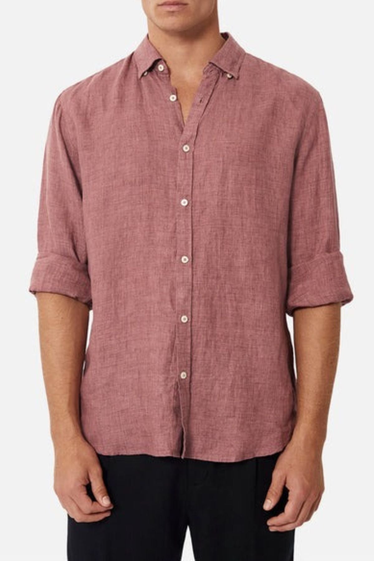 A person wearing the mauve Industrie The Midland Shirt, recognized for its INDUSTRIE branding, with rolled-up sleeves and black pants, stands against a plain white background.