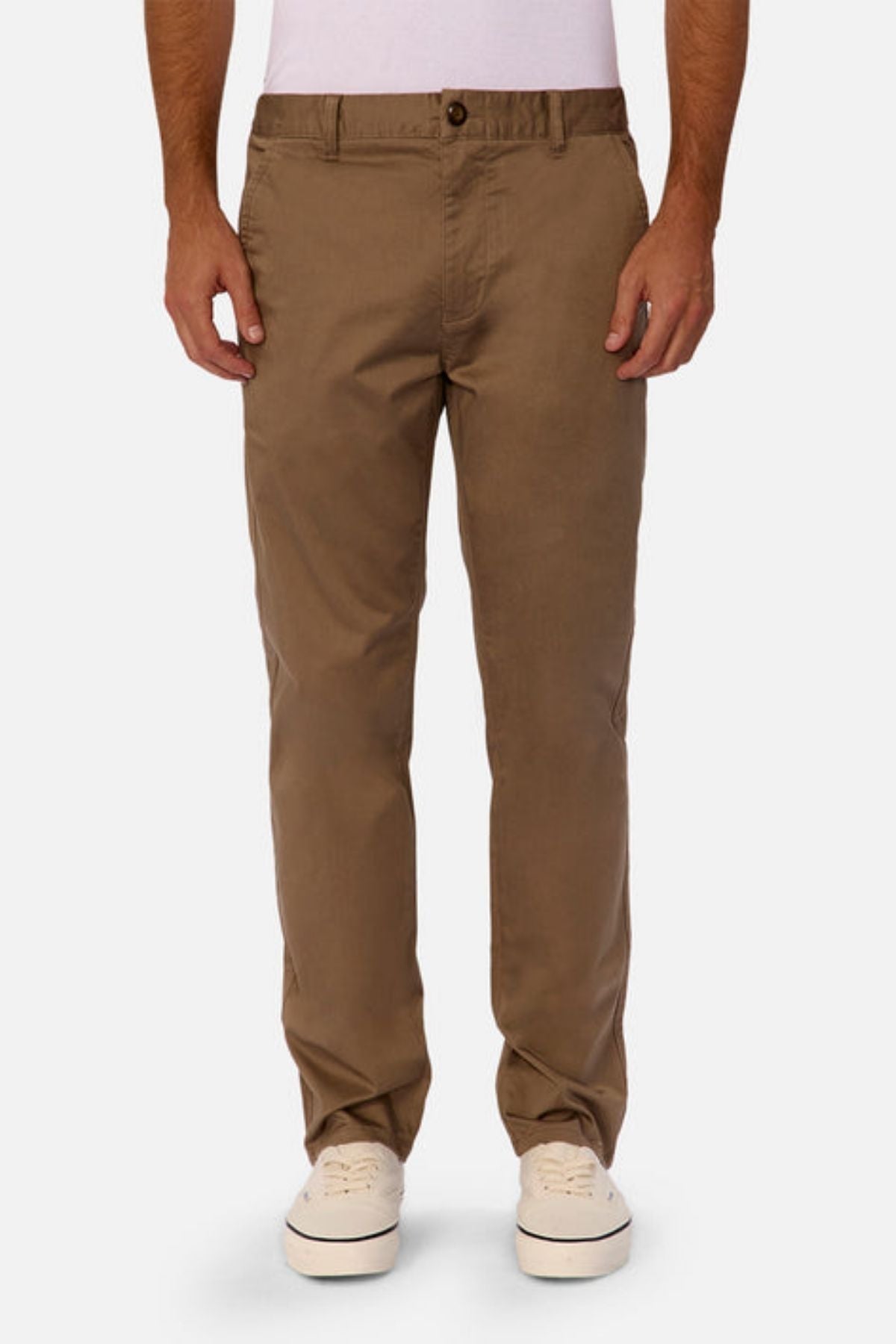 A person wearing Industrie The Regular Cuba Chino Pant in tan—a stretch cotton blend chino with a wider leg fit—and white sneakers, standing against a white background. The upper body is not fully visible.