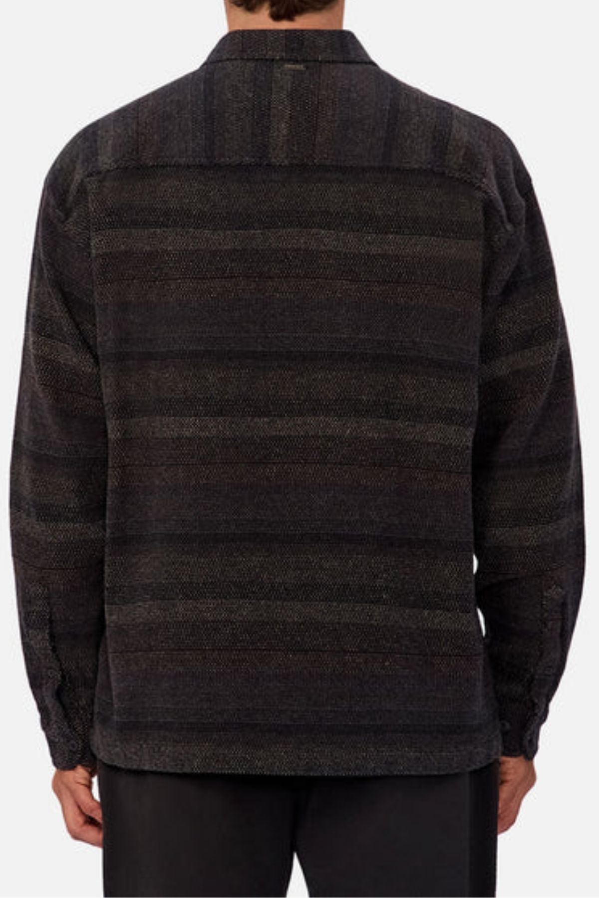 A person is seen from behind wearing the Industrie The Sonoran Long Sleeve Shirt in a regular fit, with subtle horizontal stripes and dark pants against a plain background.