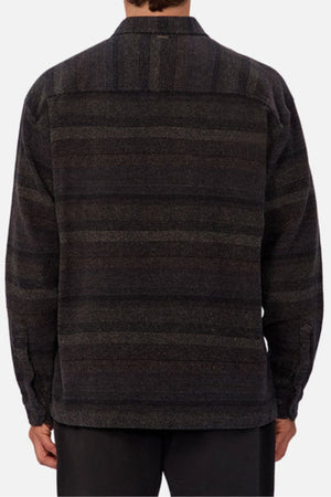 A person is seen from behind wearing the Industrie The Sonoran Long Sleeve Shirt in a regular fit, with subtle horizontal stripes and dark pants against a plain background.