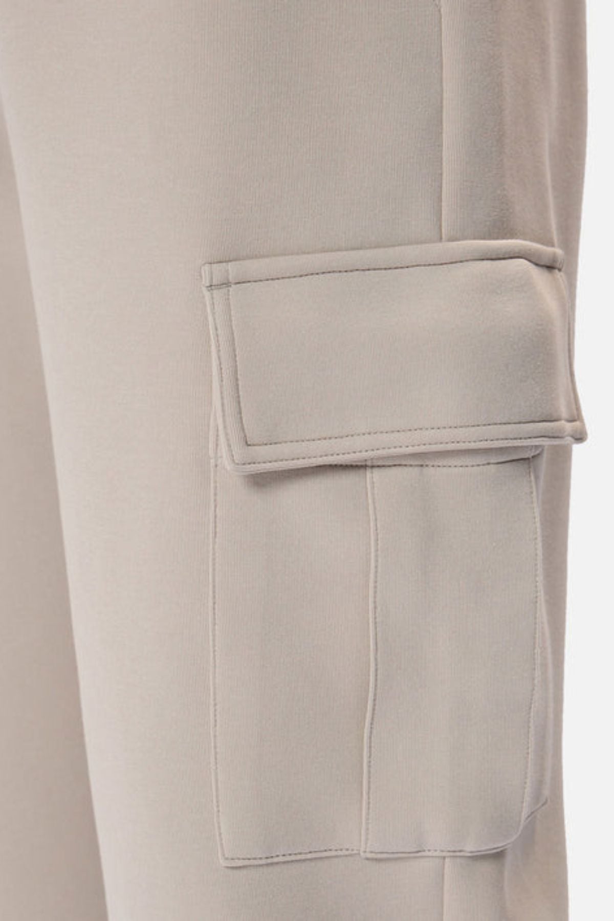 Close-up of Industrie The Tech Combat Trackpant in light beige, featuring a rectangular flap side pocket on the thigh—ideal for those who prioritize style and performance in athletic wear.