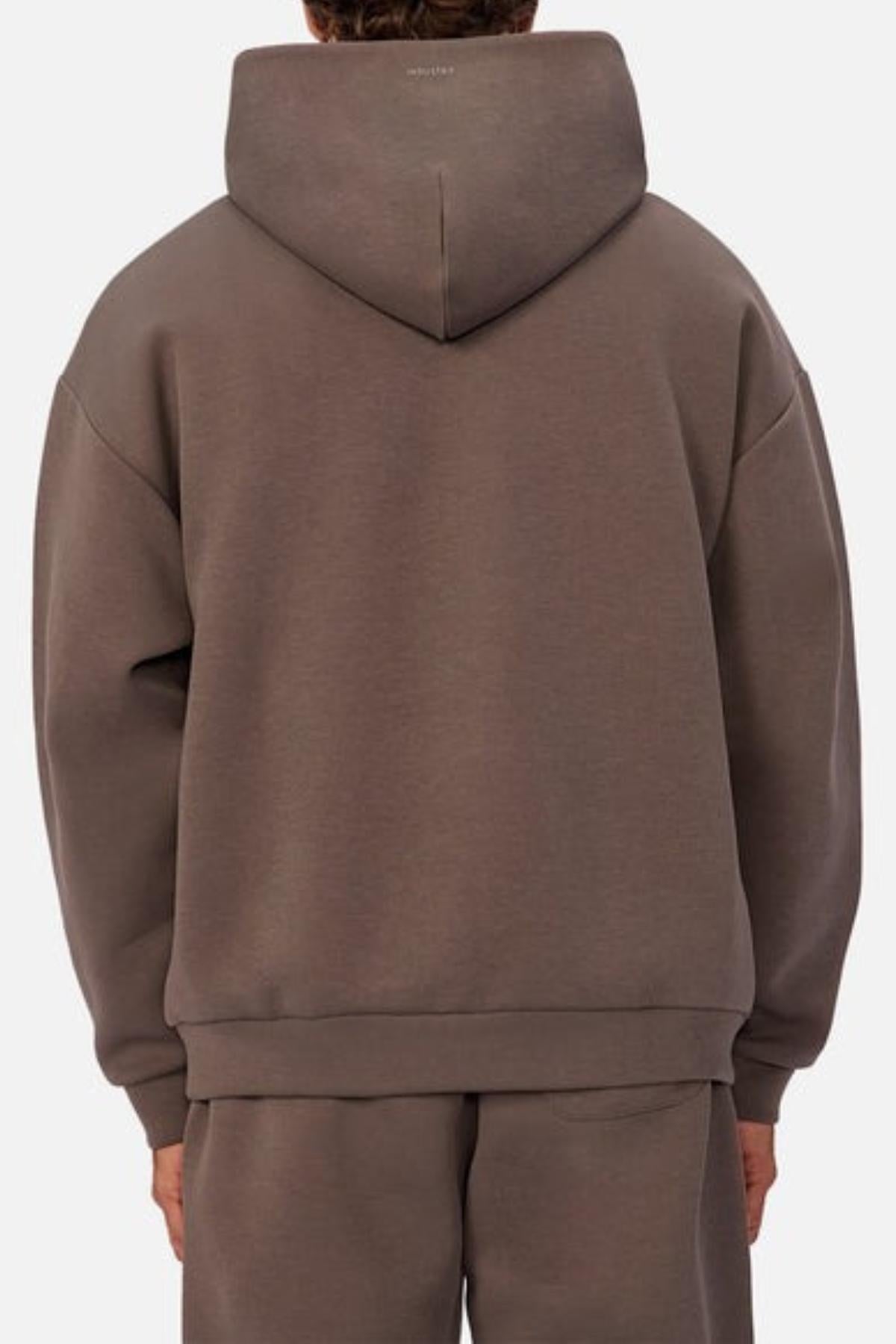 A person is shown from the back wearing an Industrie The Tech Del Sur Hood sweatshirt and matching brown sweatpants. The hood is up, covering the head, and both pieces are made of advanced athletic fabric. The background is plain white.