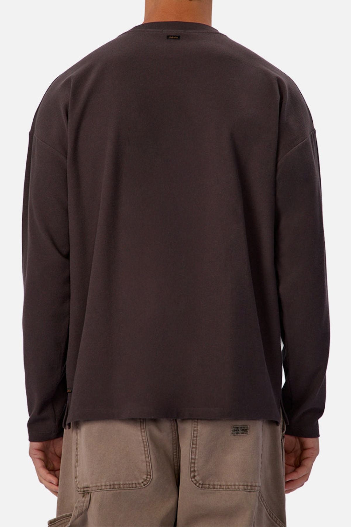 A person is shown from the back wearing an Industrie The Waffle Long Sleeve Tee in dark gray and light brown cargo shorts against a plain background.