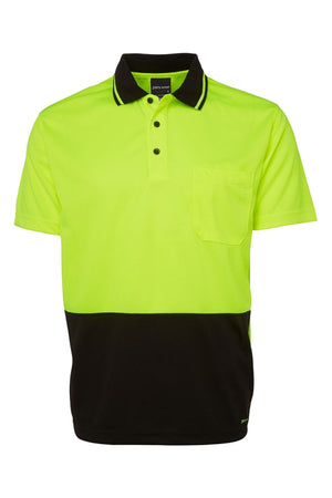 The JBs Hi Vis Non Cuff Traditional Polo is a short-sleeved, 100% polyester shirt with a neon yellow top, black bottom, black collar with yellow trim, three-button placket, and a chest pocket for high visibility.