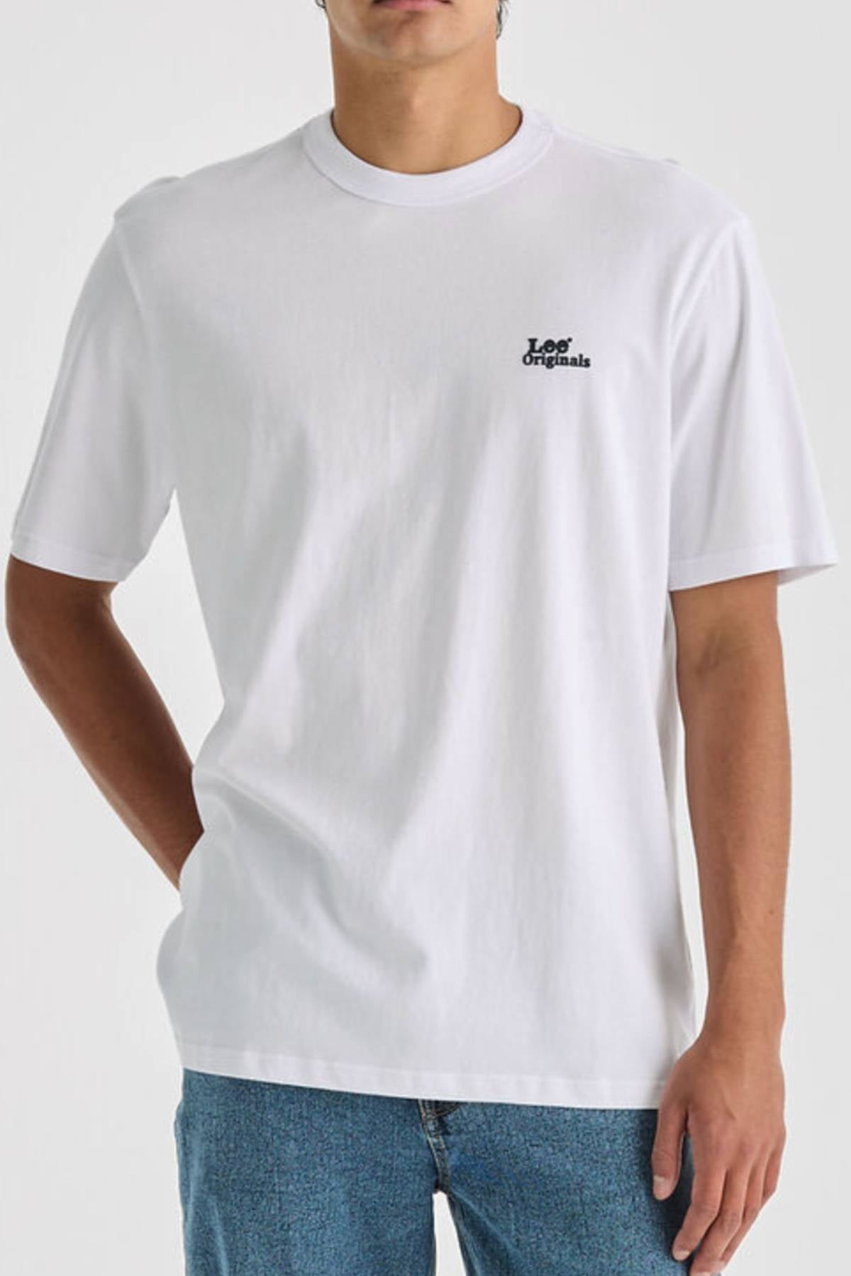 Wearing the Lee Originals Relaxed Tee made from 100% cotton and blue jeans, a person stands with one hand in their pocket against a neutral background.