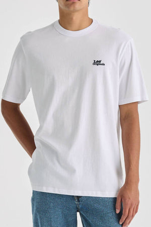 Wearing the Lee Originals Relaxed Tee made from 100% cotton and blue jeans, a person stands with one hand in their pocket against a neutral background.