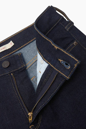 Close-up of Levis 311 Shaping Skinny Jean in dark blue, showing the partially open waistband, zipper, and button fly with a focus on inner fabric, stitching details, and subtle tummy control elements.