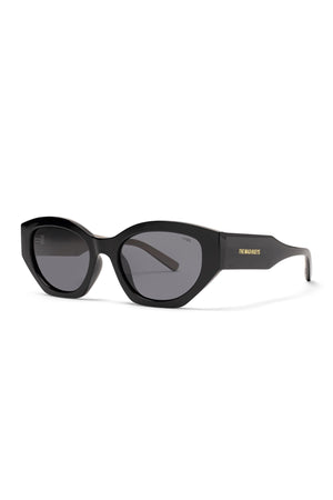 A pair of Liive Cabron Polarised Sunglasses featuring a black cat-eye frame, dark smoke lenses, and "THE MAD HUEYS" in gold lettering on the left arm.