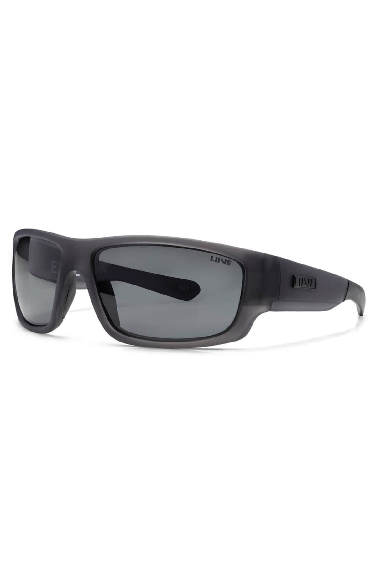 The Liive Exile Polar Sunglasses are black wraparound shades with dark polarised lenses, matte finish, thick sturdy frames for UV protection, and the “LIIVE” brand name on the left arm.