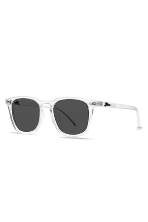 Introducing the Liive Manhattan Polar Sunglasses: a pair of stylish eyewear featuring clear, transparent frames and dark, rectangular polarized lenses. The sleek design is further enhanced by its transparent arms. Expertly crafted from lightweight polycarbonate, these sunglasses offer UV protection and are presented against a plain white background.