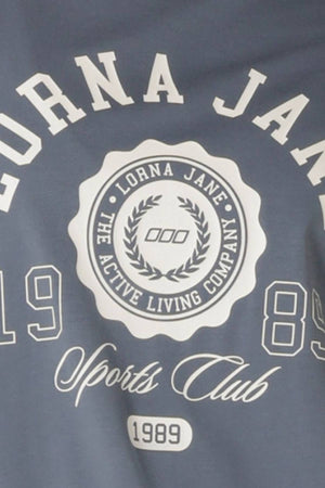 The Lorna Jane Active Living Relaxed T-Shirt features a limited edition circular logo with laurels, "The Active Living Company," 1989, and "Sports Club" in script above the year.