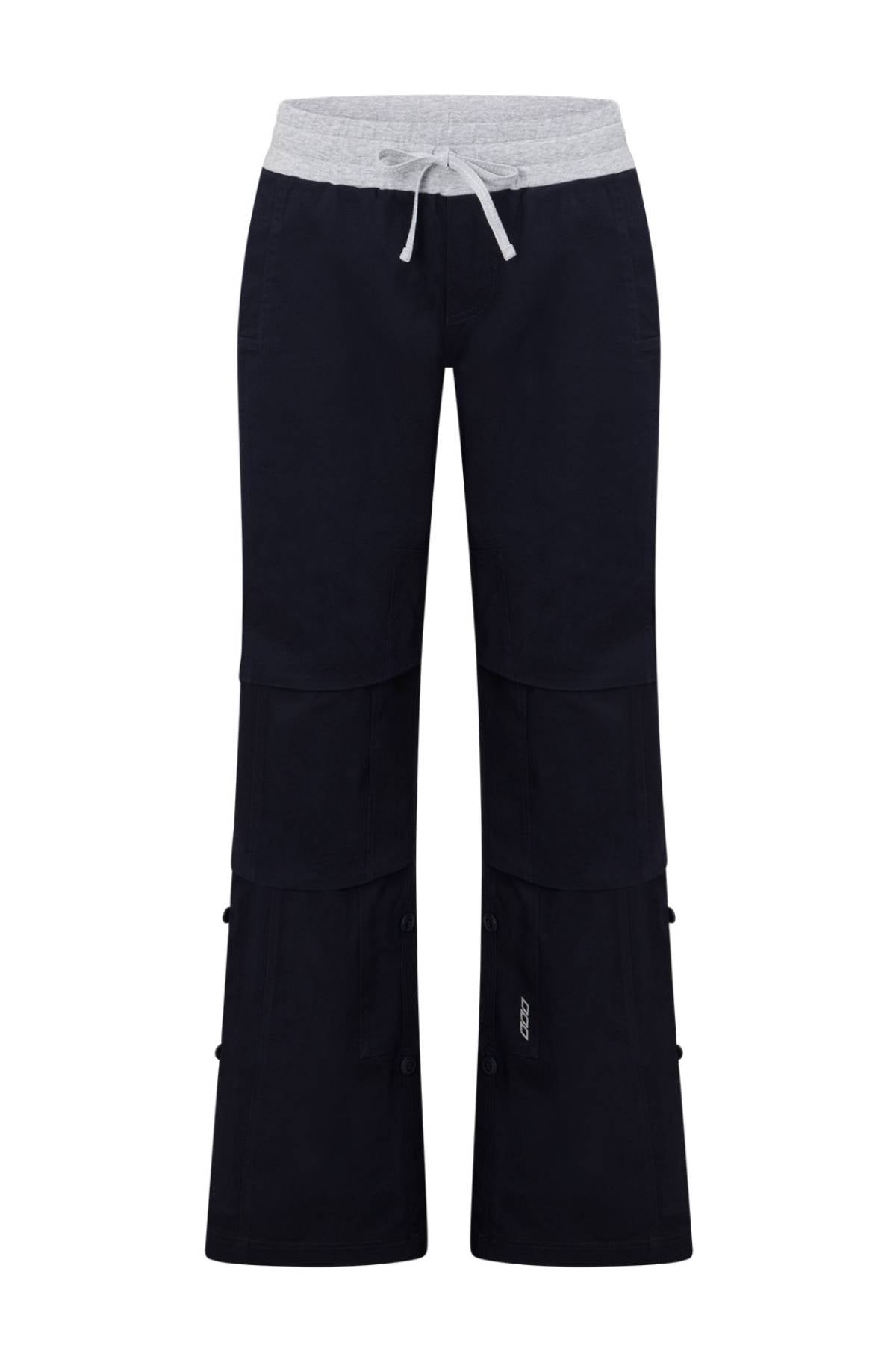 The Lorna Jane Flashdance Work Pant features black cargo styling with a light gray elastic waistband and drawstring, visible seams, multi-pocket design, side pockets, and buttons for adjustable length.