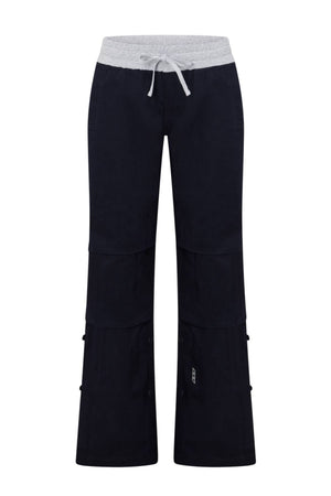 The Lorna Jane Flashdance Work Pant features black cargo styling with a light gray elastic waistband and drawstring, visible seams, multi-pocket design, side pockets, and buttons for adjustable length.