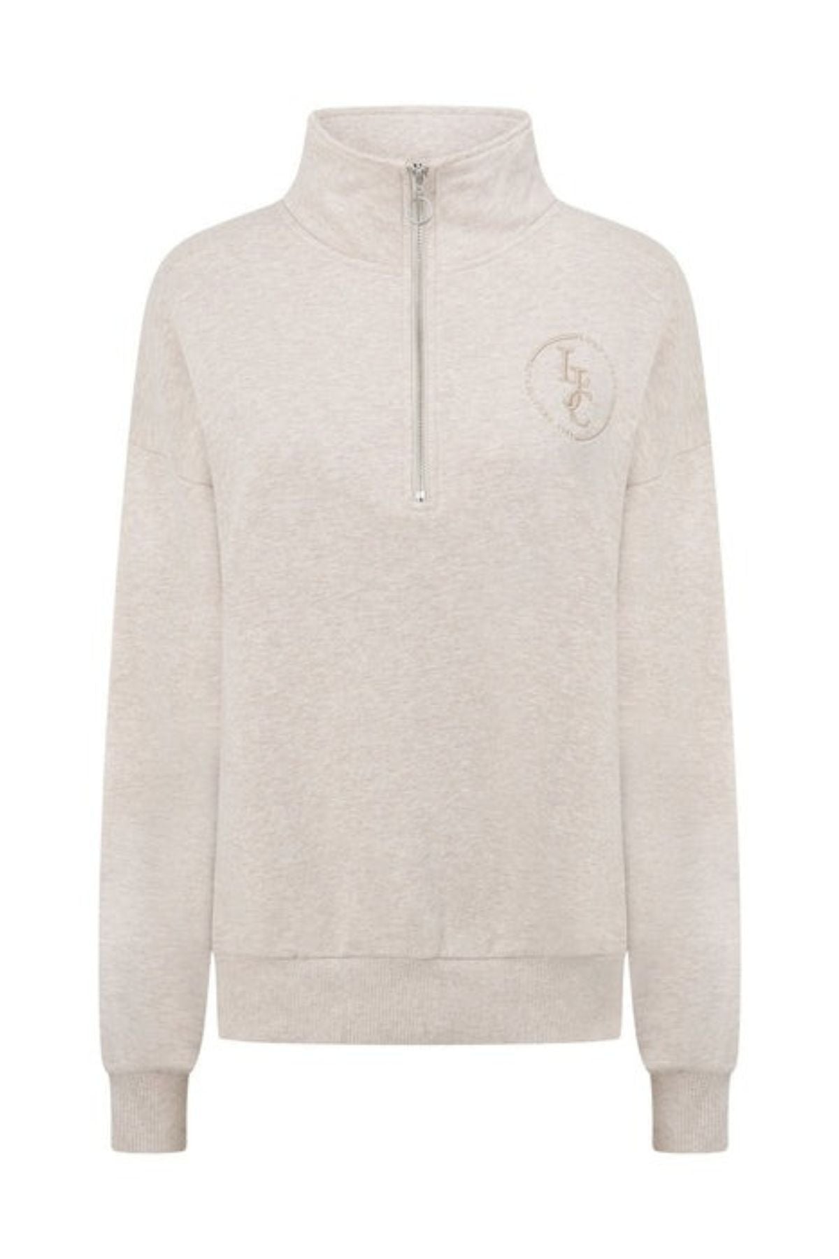 The Lorna Jane LJC Heritage Quarter Zip Sweat is crafted from soft beige cotton terry with a high collar, ribbed cuffs and hem, and an embroidered circular "LFC" logo on the left chest for a simple, casual look.
