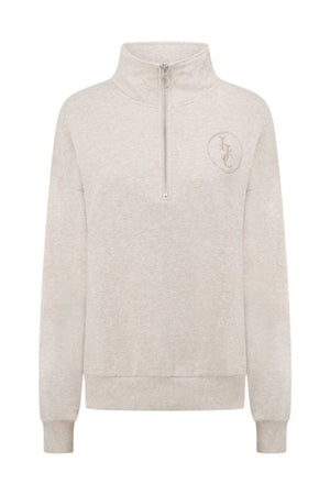 The Lorna Jane LJC Heritage Quarter Zip Sweat is crafted from soft beige cotton terry with a high collar, ribbed cuffs and hem, and an embroidered circular "LFC" logo on the left chest for a simple, casual look.