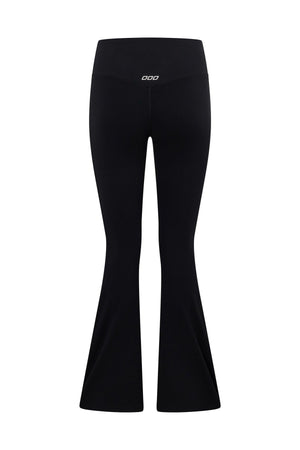 The Lorna Jane Lotus Flared Legging is a black, high-waisted flared legging with a small white logo on the waistband. Shown from the back against a white background, it features a flattering high-rise fit.
