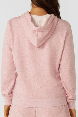 A person wears the Lorna Jane Lotus Hoodie in light pink with matching pants, shown from the back. This cotton blend hoodie features a relaxed fit and hood down, offering a comfortable, stylish look.