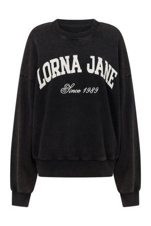 The Lorna Jane New Sport Washed Sweatshirt is a black, vintage-inspired oversized fit, featuring "LORNA JANE" in bold white lettering and "Since 1989" below, crafted from soft cotton terry.
