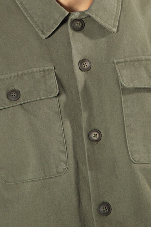 Close-up of the olive green Mr Simple Stockyard Sherpa Jacket in a Regular Fit, showing two chest pockets and dark buttons, with part of the collar and upper chest visible.
