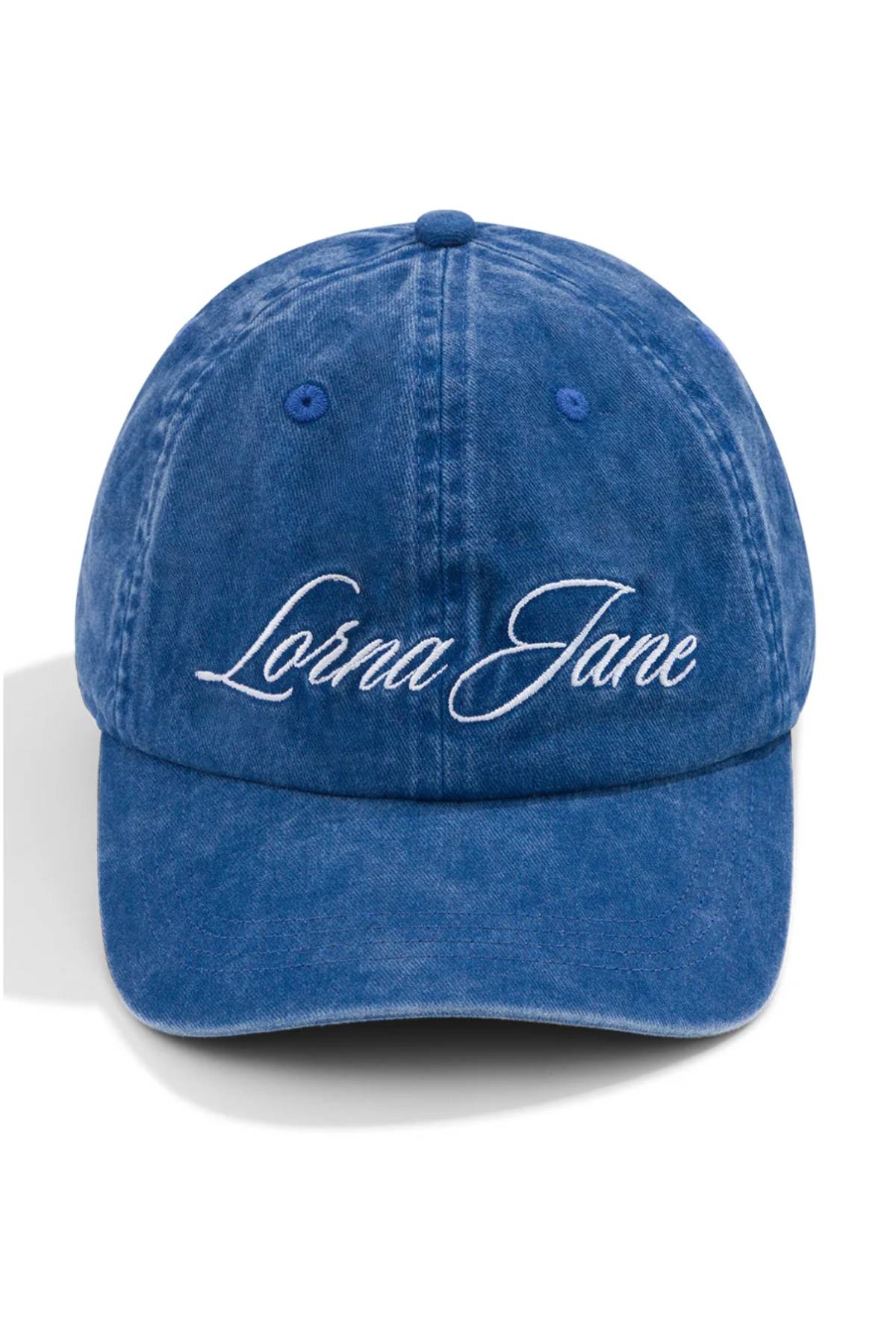 The Lorna Jane Heritage Washed Logo Cap is a blue vintage-wash denim cap with "Lorna Jane" embroidered in white cursive on the front.