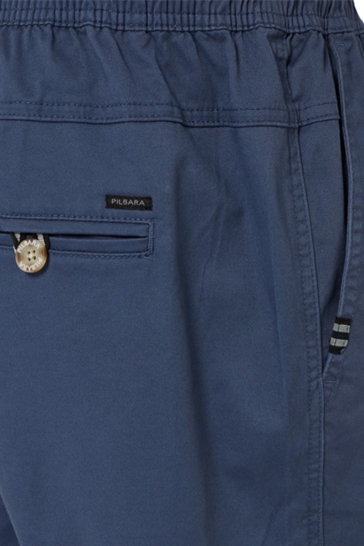 Close-up of Pilbara Cotton Stretch Short in blue with elastic waist, comfy fit, small buttoned pocket with "PILBARA" label, and a side seam pocket with striped trim—perfect cotton stretch shorts for daily wear.