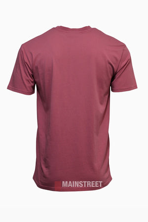 The Pilbara Oil Can T-Shirt is a soft maroon cotton tee shown from the back, featuring "MAINSTREET" in white uppercase letters near the bottom hem—a comfortable regional pride shirt for everyday wear.
