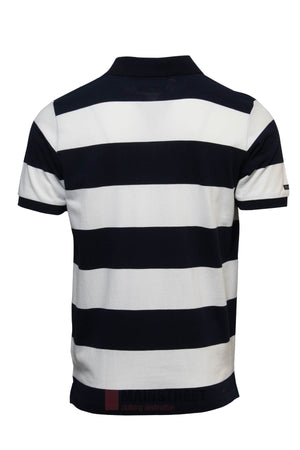 The Pilbara Striped Polo features wide horizontal black and white stripes, a classic collar, and a straight hem. Made from 100% cotton, this short-sleeved polo is shown from the back.