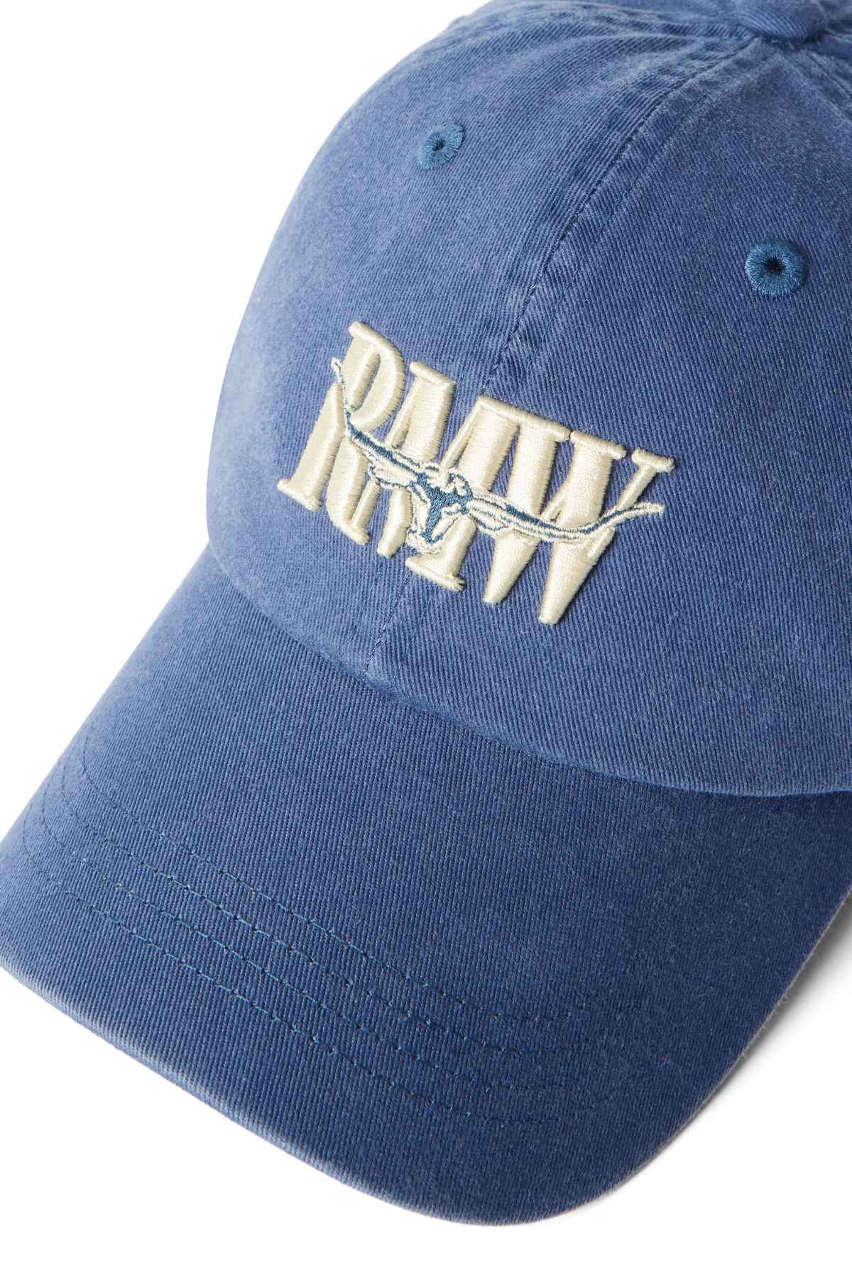 Blue cotton twill RM Williams Steers Head Cap featuring an archive-inspired logo with embroidered white "RAW" letters and a bird in flight on the front.