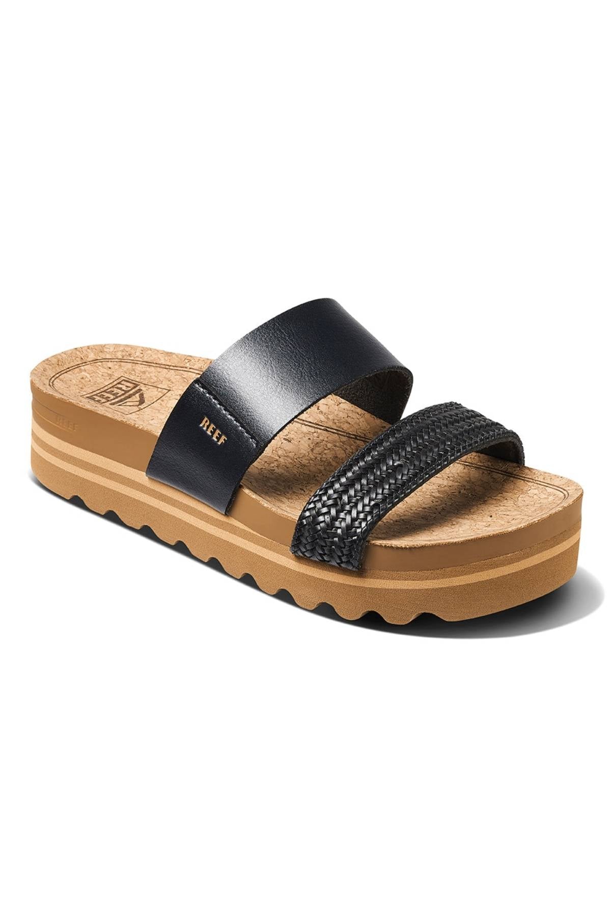 The REEF Cushion Vista Hi features a tan cork footbed, black leather strap, textured black toe strap, and thick cushioned sole for arch support. "REEF" is printed in gold on the upper strap.