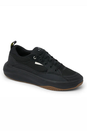 The Reef Fanning Mens Shoe is a black low-top sneaker with black laces, cushioned comfort, thick sole, brown outsole, small white side accent, and a built-in bottle opener—shown on a white background.