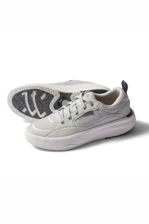 The Reef Fanning Mens Shoe in light gray features white midsoles, gray textured outsoles with a visible sole pattern, and includes a built-in bottle opener. One shoe is upright while the other shows the sole design.