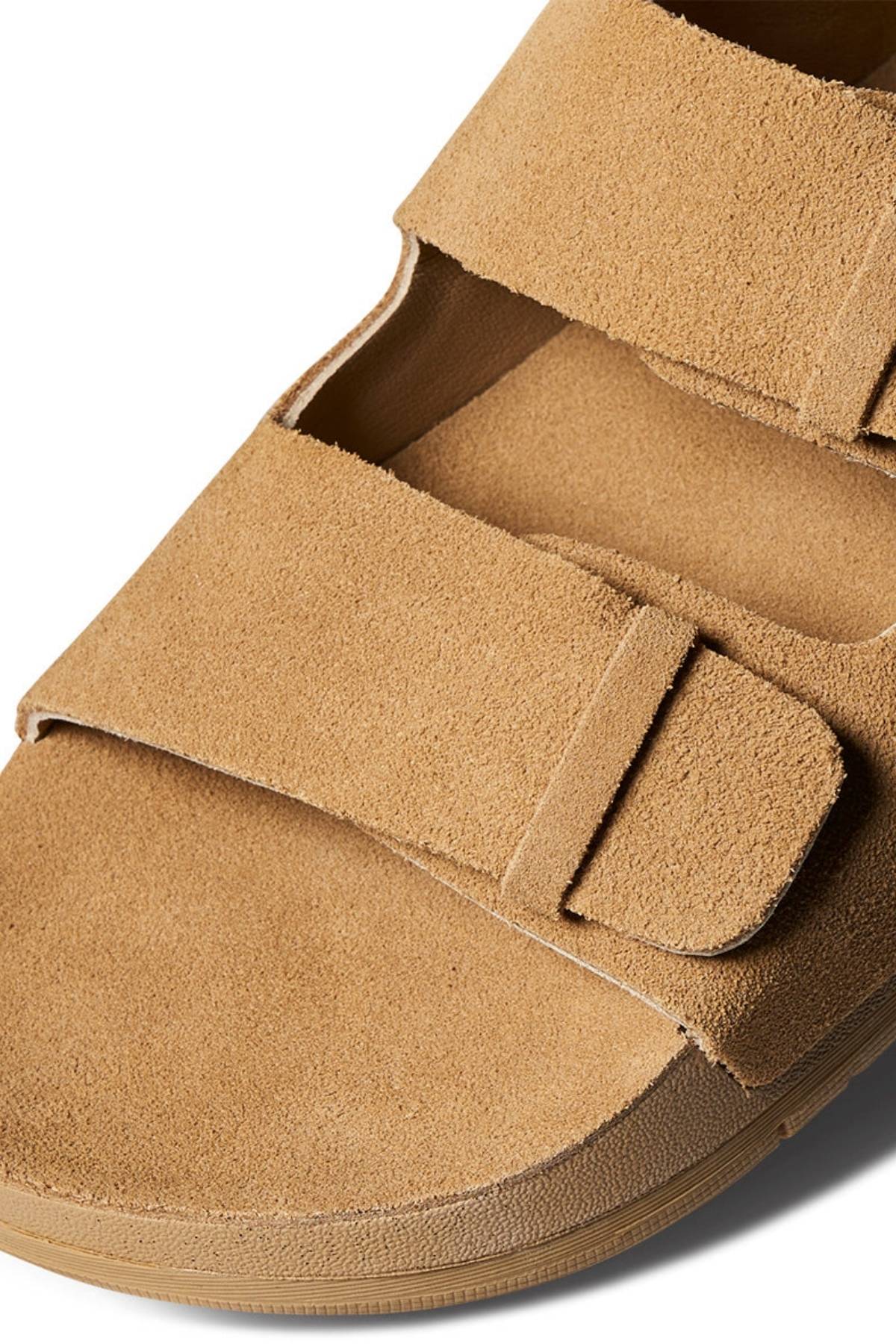 Close-up of the REEF Ojai Two Bar tan suede sandal with two wide Velcro straps, showcasing its soft texture and supportive sole. These sandals deliver comfort for everyday wear, photographed on a clean white background.