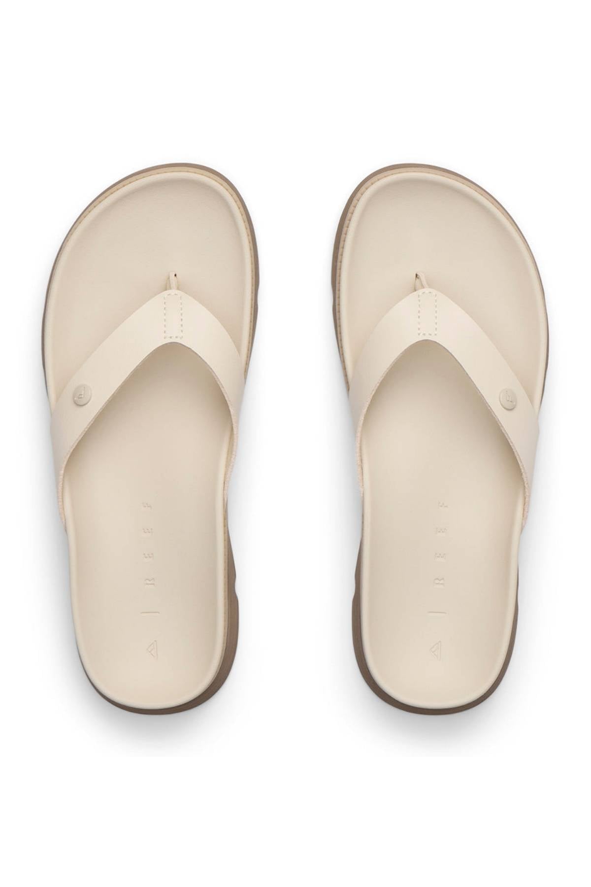 The REEF Vista Luxe Vivianahh is a pair of beige vegan leather sandals featuring wide straps and a cushioned footbed, shown from above on a white background.