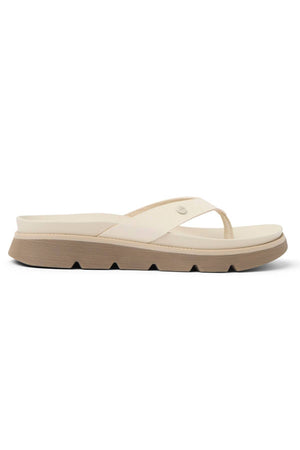 The REEF Vista Luxe Vivianahh is a beige flip-flop sandal featuring a thick ridged sole, cushioned footbed, and a simple wide strap, shown in side profile against a white background.