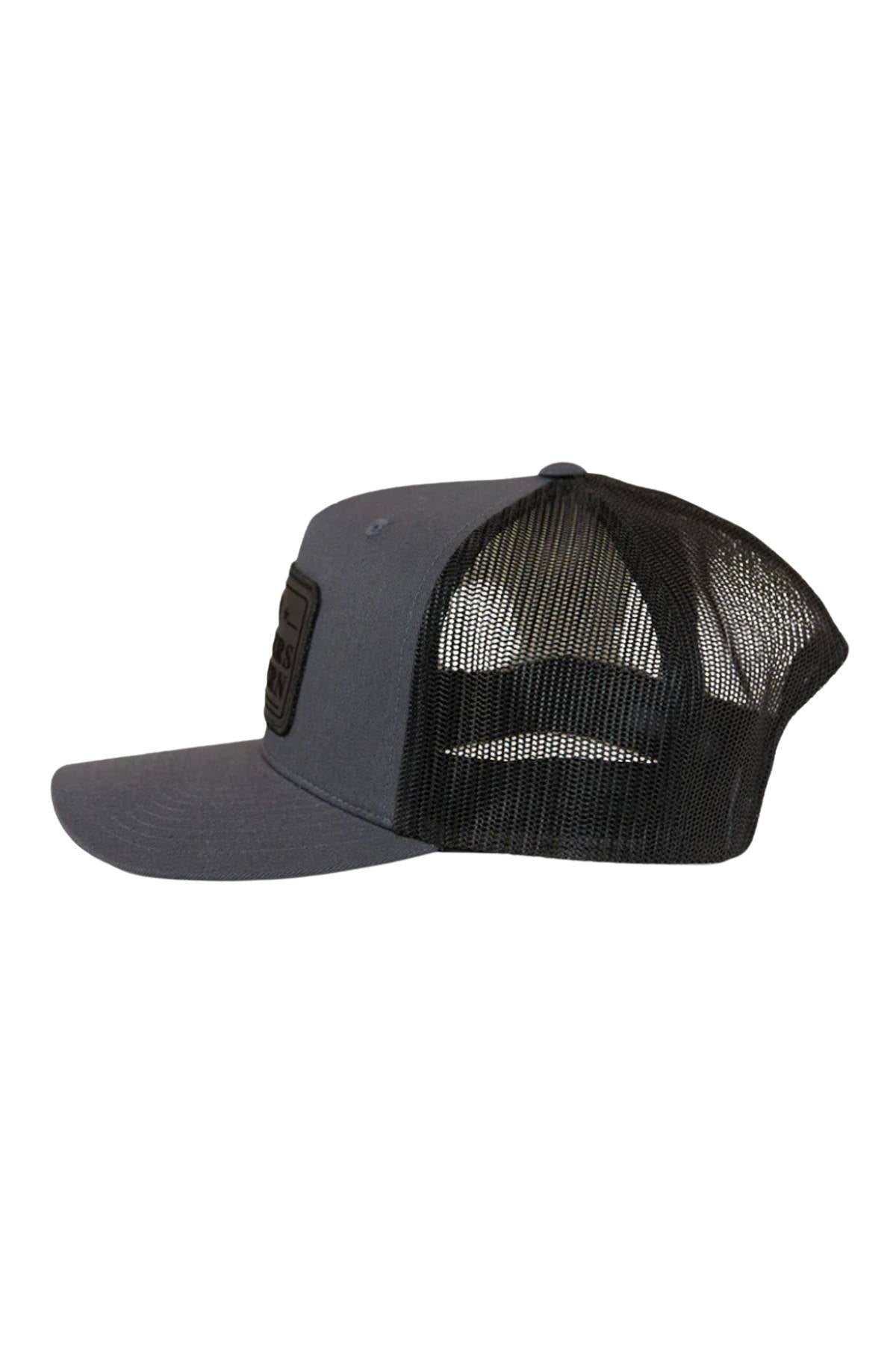The Ringers Western Awol Trucker Cap features a gray flat brim, black mesh back, snapback closure, and a black front patch—shown side view on a white background.