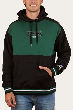 Someone wearing a green and black Ringers Western Barrow Creek Pullover Hoodie with "RINGERS WESTERN" on the chest, an embroidered sleeve patch, front pocket, drawstrings, and paired with blue jeans.