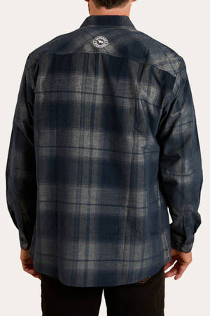 A person seen from behind wears a long-sleeve, dark blue Ringers Western Glenferrie Flannel Shirt with a circular logo near the upper center. The 100% cotton shirt drapes comfortably as their hands rest relaxed at their sides.