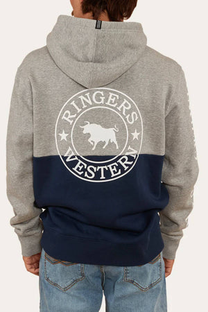 A person stands with their back to the camera wearing the Ringers Western Hahndorf Hoodie, a relaxed-fit, two-tone hoodie with a grey top, navy blue bottom, and a "Ringers Western" bull and stars logo.