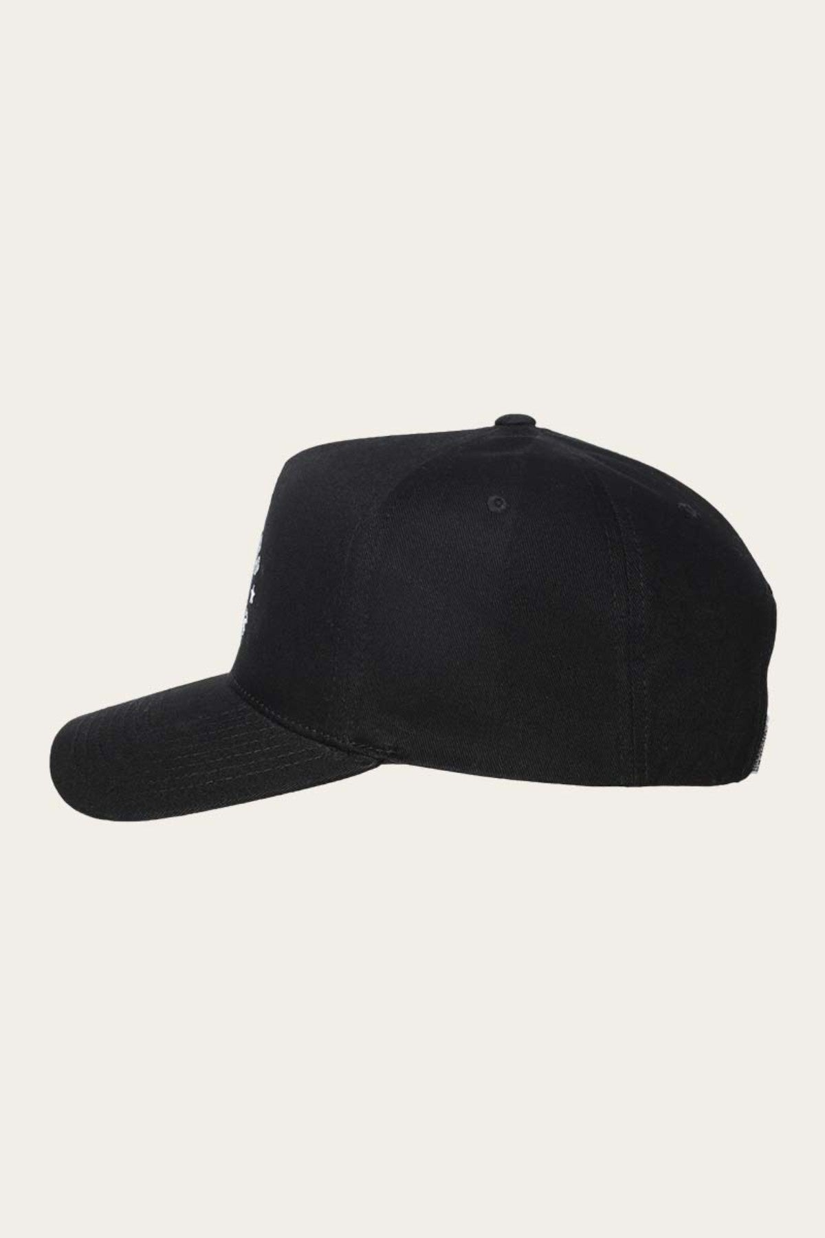 A black Ringers Western Icon Baseball Cap is shown in side profile. The cap, designed in a classic baseball cap style, features a curved visor and a button on top. Made from cotton twill, it stands out against the light beige background, creating a striking contrast with its dark color.