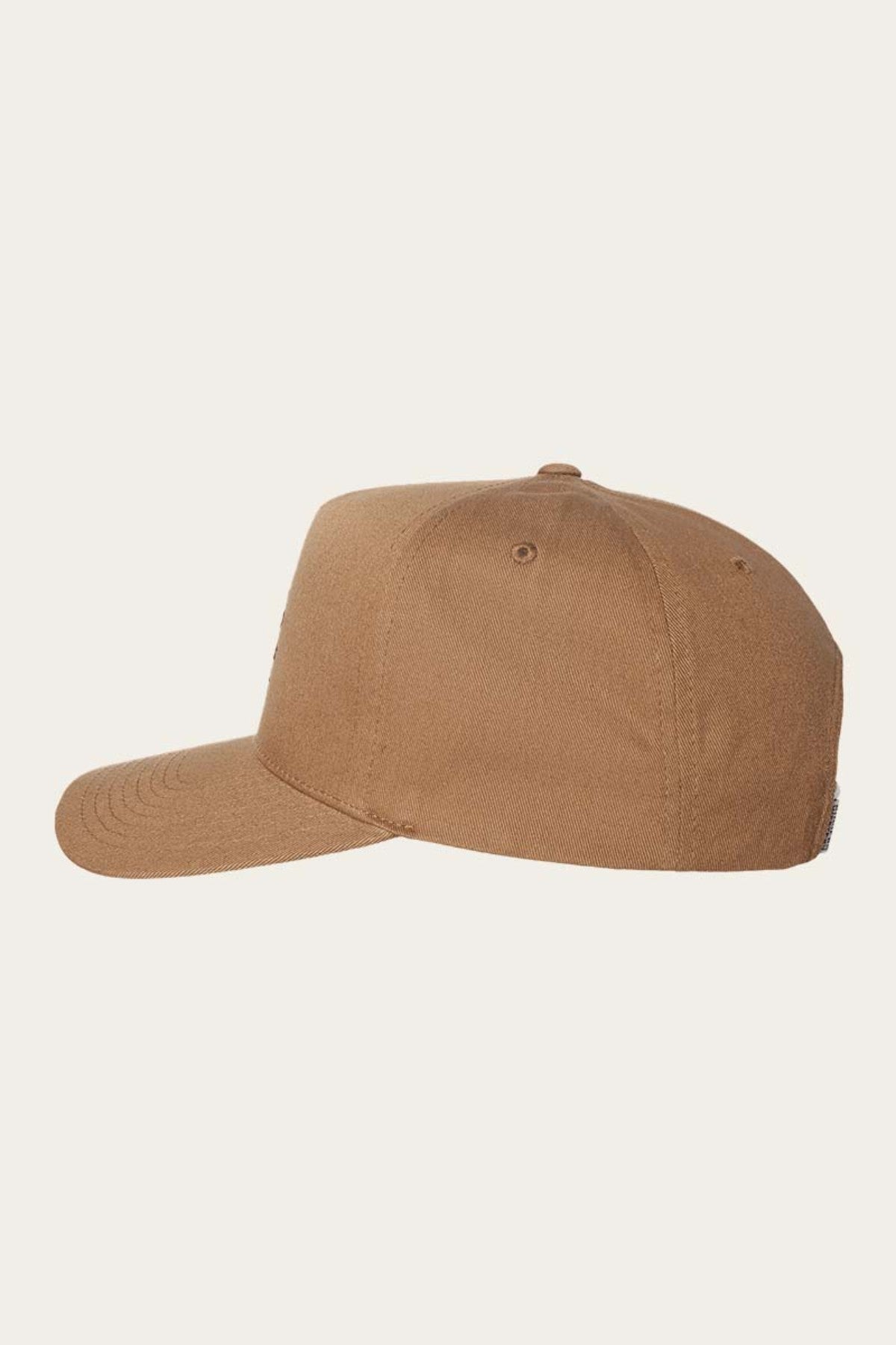 Side view of the Ringers Western Icon Baseball Cap showcasing its plain brown color with a curved brim, six-panel design, and a button on top. Crafted from cotton twill, the cap features ventilation eyelets and visible stitching along the panels and brim. An adjustable strap ensures a perfect fit against the light beige background.