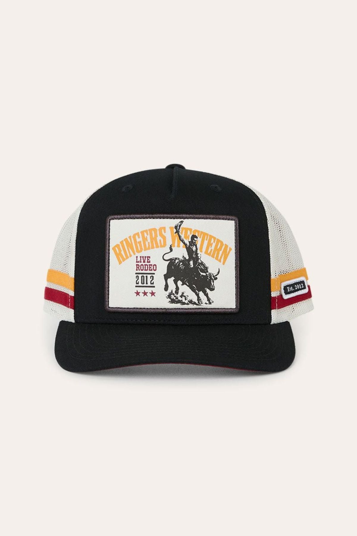 The Ringers Western Live Rodeo Deep Fit Trucker Cap is a black and white trucker hat featuring a patch of a rodeo rider on a bull, along with the text “Ringers Western,” “Live Rodeo 2012,” and three stars. Bold red and yellow stripes on the sides complete its classic rodeo look.