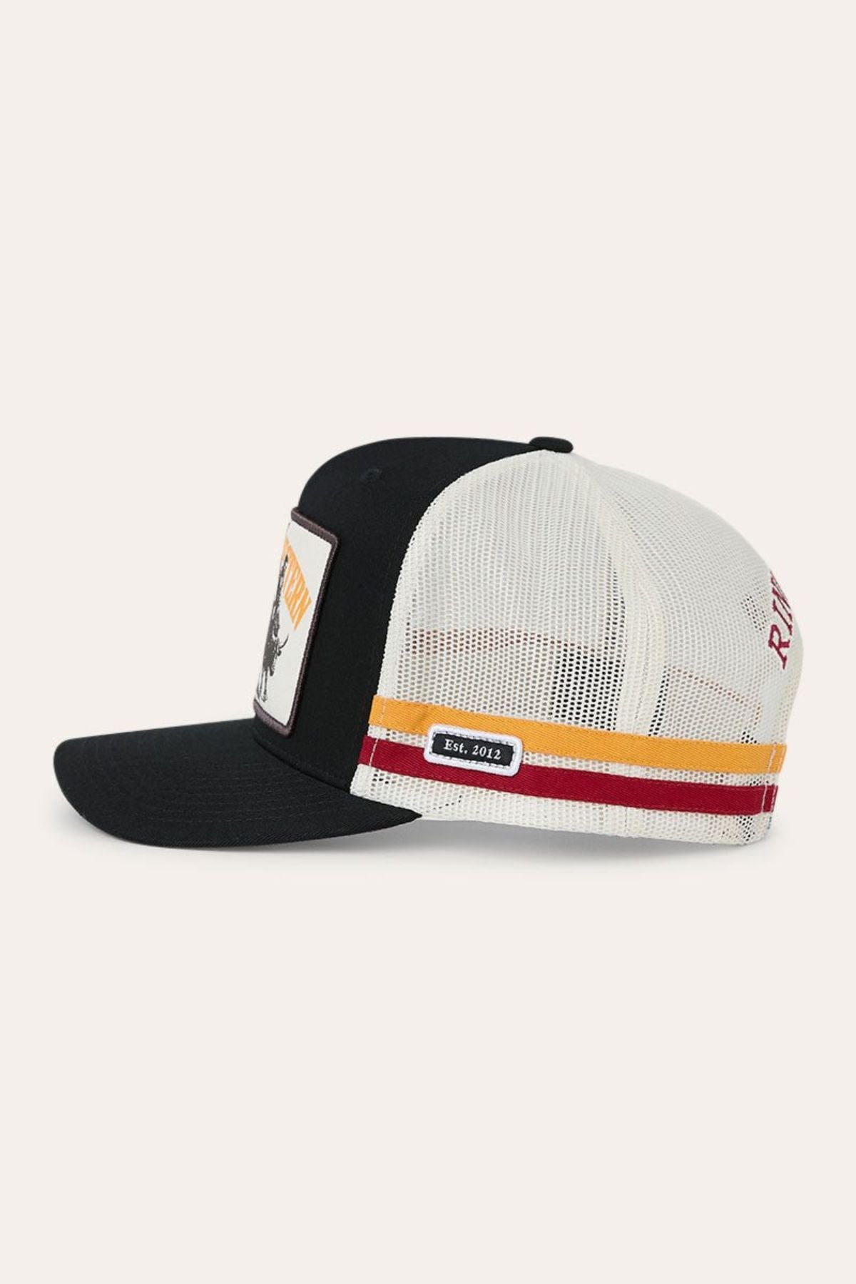 Side view of the Ringers Western Live Rodeo Deep Fit Trucker Cap in black and white mesh featuring a curved brim, rectangular front patch, colored stripes, and a small “Est. 1972” label on the mesh side.