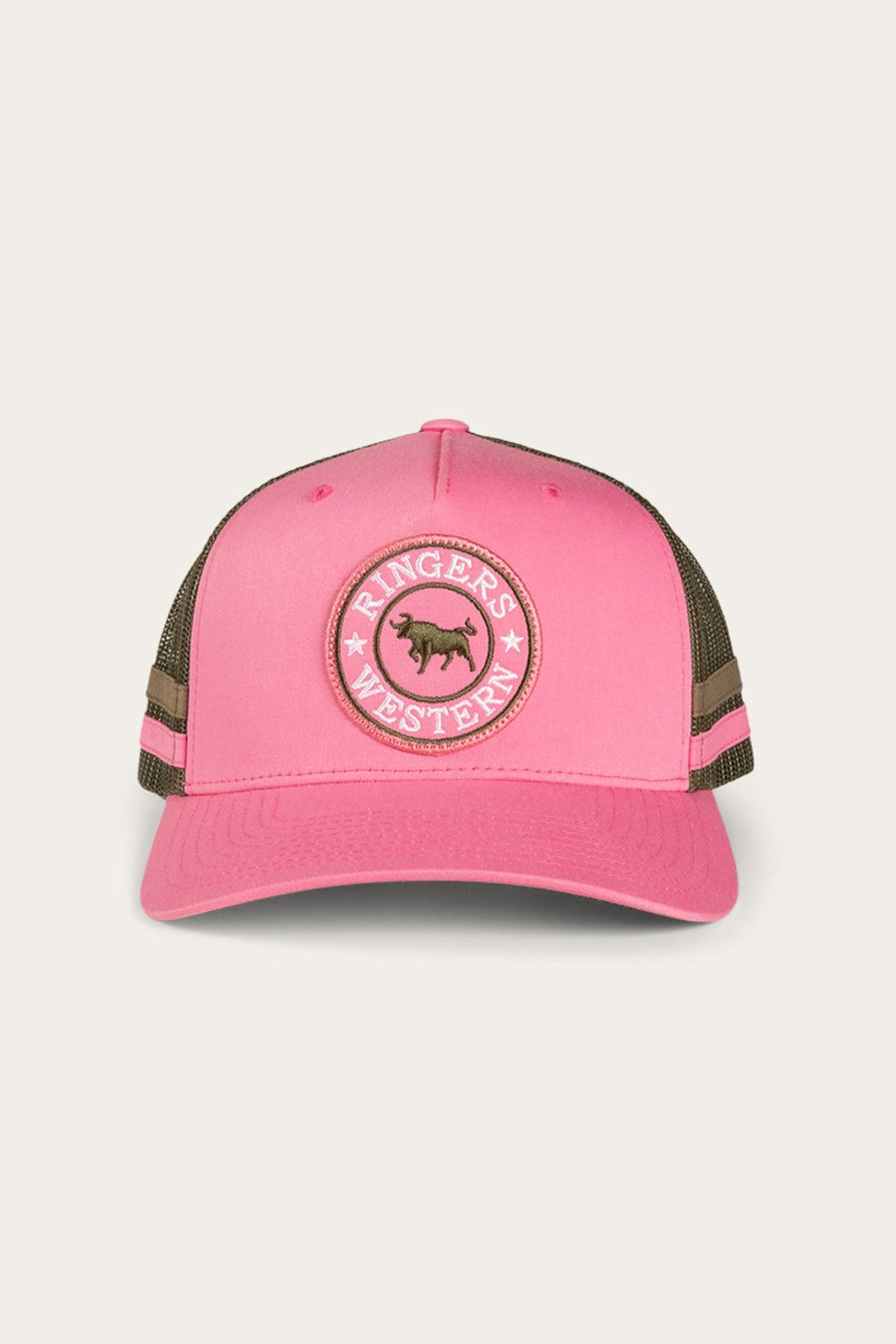 The Ringers Western McCoy Trucker Cap is a stylish blend of pink and green, showcasing a circular patch with a bull and the brand's name in white text. It features a cotton twill green mesh back, a pink front panel, and a curved pink brim.