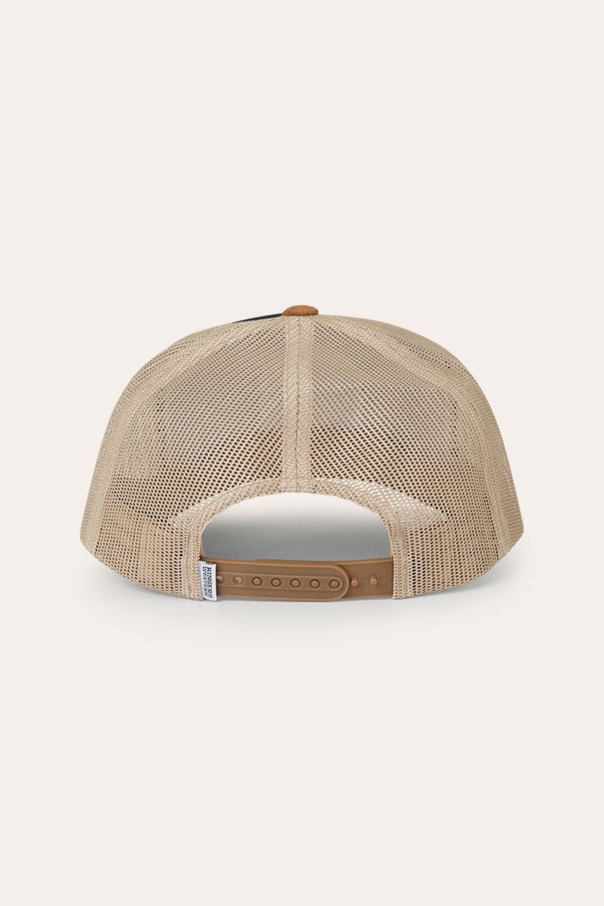 The Ringers Western Outback Hide Roadhouse Trucker Cap is displayed from the back, highlighting its beige mesh panels, adjustable tan plastic snapback closure, and a small white tag on the left side. The cap is set against a plain off-white background.