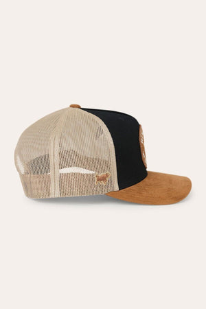 The Ringers Western Outback Hide Roadhouse Trucker Cap features a beige mesh back, a black front panel, and a brown suede bill, displayed from the side against a light background.