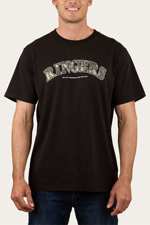 A person wearing a Ringers Western Princeton Loose Fit T-Shirt featuring "RINGERS" in bold across the chest with smaller text below, paired with blue jeans.
