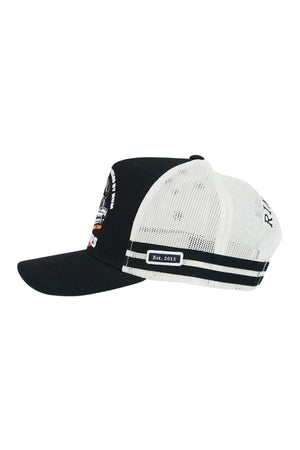 The Ringers Western Rum Runner Trucker Cap features a black front panel and brim, white mesh back with black stripes, and a small "Est. 2013" patch on the side.