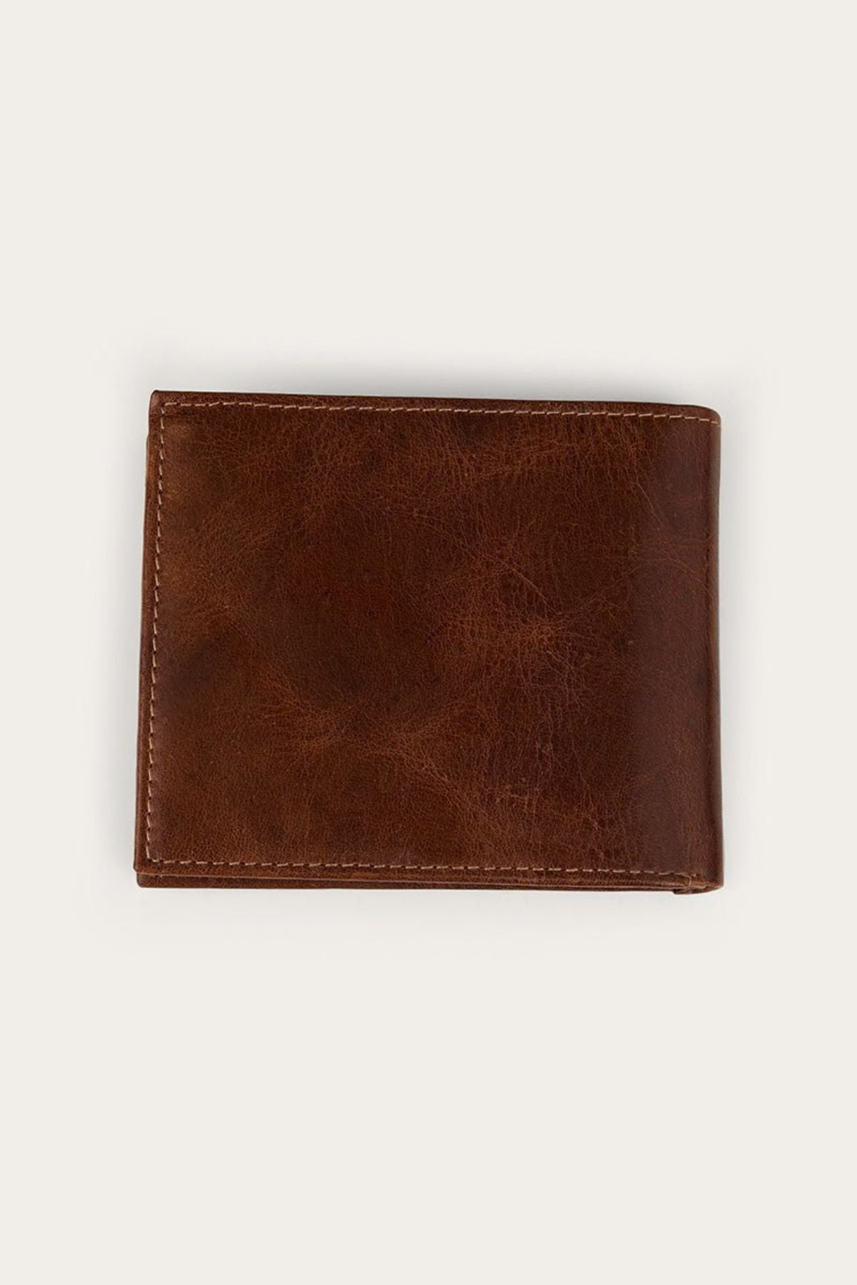 The Ringers Western Toro Biggo Wallet, a closed brown wallet with visible stitching, is placed on a plain, light-colored background.