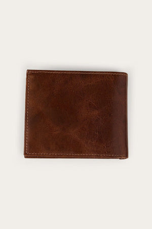 The Ringers Western Toro Biggo Wallet, a closed brown wallet with visible stitching, is placed on a plain, light-colored background.